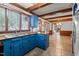 Cozy kitchen with wood countertops, blue cabinets, and view into living area at 1100 Cardinals Knob, Rocky Mount, NC 27804