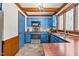 Charming kitchen featuring blue cabinets, butcher block countertops, and stainless-steel appliances at 1100 Cardinals Knob, Rocky Mount, NC 27804