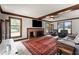 Bright living room boasts a brick fireplace, comfortable seating, and ceiling beams at 1100 Cardinals Knob, Rocky Mount, NC 27804