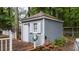 View of a charming outbuilding with a gray shingle siding and a small wooden deck at 1100 Cardinals Knob, Rocky Mount, NC 27804