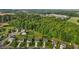 An aerial view highlighting the neighborhood and surrounding lush green space and a nearby forest at 1301 Torrey Pines Ct, Mebane, NC 27302