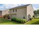 Backyard featuring a deck with pergola, grill, lush landscaping, and a spacious lawn at 1301 Torrey Pines Ct, Mebane, NC 27302