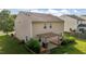 Backyard with tan siding, a wood pergola, outdoor kitchen area, and green grass at 1301 Torrey Pines Ct, Mebane, NC 27302