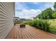 Wood deck with a built-in bench seating and green bushes around the border at 1301 Torrey Pines Ct, Mebane, NC 27302