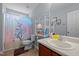 Colorful bathroom with a unicorn shower curtain and plenty of counter space and storage at 1301 Torrey Pines Ct, Mebane, NC 27302