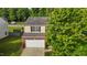 Two-story home with a brick foundation, tan siding and green landscaping at 1301 Torrey Pines Ct, Mebane, NC 27302