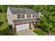 Two-story home with neutral siding, brick accents, and a well-maintained front yard at 1301 Torrey Pines Ct, Mebane, NC 27302