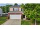 Charming two-story home with brick accents, a two-car garage, and landscaped front yard at 1301 Torrey Pines Ct, Mebane, NC 27302