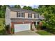 Charming two-story home with brick accents, a two-car garage, and manicured landscaping at 1301 Torrey Pines Ct, Mebane, NC 27302