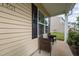 Charming front porch with two wicker chairs and view of the house number at 1301 Torrey Pines Ct, Mebane, NC 27302