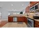 Well-equipped kitchen with stainless steel appliances, tile backsplash, and open view to the living room at 1301 Torrey Pines Ct, Mebane, NC 27302