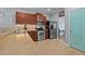 Functional kitchen features stainless steel appliances, tiled floor, and wood cabinets at 1301 Torrey Pines Ct, Mebane, NC 27302