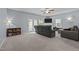 Bright living room with a fireplace, plush seating, and ample natural light at 1301 Torrey Pines Ct, Mebane, NC 27302
