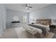 Bright main bedroom features neutral decor, a decorative round mirror, and a comfortable seating bench at 1301 Torrey Pines Ct, Mebane, NC 27302
