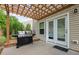 Patio with a grill, string lights on a wood pergola, and white trimmed windows at 1301 Torrey Pines Ct, Mebane, NC 27302