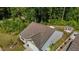 Aerial view of the house showcasing its landscaped yard, deck, and surrounding lush green forest at 1574 Dorsett Ln, Creedmoor, NC 27522