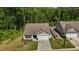 Inviting single-Gathering home featuring a well-manicured lawn, an attached garage, and surrounded by lush trees at 1574 Dorsett Ln, Creedmoor, NC 27522