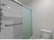 Bathroom featuring a modern glass enclosed shower with white subway tile surround and brushed metal fixtures at 1574 Dorsett Ln, Creedmoor, NC 27522