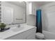 Clean bathroom with a large vanity, a patterned mirror, and a shower/tub combo with a blue curtain at 1574 Dorsett Ln, Creedmoor, NC 27522