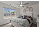 Comfortable bedroom featuring a ceiling fan, a large window with natural light, and a queen bed at 1574 Dorsett Ln, Creedmoor, NC 27522