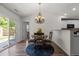Cozy dining area with stylish chandelier, round table, and sliding glass door to patio at 1574 Dorsett Ln, Creedmoor, NC 27522