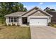 Charming single-story home featuring a well-maintained lawn and a two-car garage at 1574 Dorsett Ln, Creedmoor, NC 27522