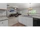 Open floor plan featuring kitchen with granite counters and a living room with leather furniture and a ceiling fan at 1574 Dorsett Ln, Creedmoor, NC 27522