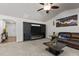 Open living room with a fireplace, TV, and an adjacent view of the dining area at 1574 Dorsett Ln, Creedmoor, NC 27522
