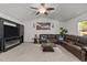 Bright living room with large sectional, ceiling fan, and modern entertainment center at 1574 Dorsett Ln, Creedmoor, NC 27522