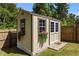 Charming shed with a window and flower boxes offering additional storage space in the backyard at 1574 Dorsett Ln, Creedmoor, NC 27522