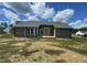 New construction home with vinyl siding, wooden deck, gray roof, and spacious backyard at 158 Sourgum Ct, Zebulon, NC 27597