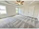 Large bedroom with trey ceiling, neutral paint, ceiling fan, natural light and cozy carpeting at 158 Sourgum Ct, Zebulon, NC 27597