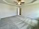 Large bedroom features trey ceiling, neutral paint, ceiling fan, natural light and cozy carpeting at 158 Sourgum Ct, Zebulon, NC 27597