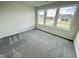 A light-filled bedroom with large windows offering neighborhood views at 158 Sourgum Ct, Zebulon, NC 27597
