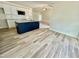 Stylish kitchen with a navy island, granite counters, stainless steel appliances, and white cabinetry at 158 Sourgum Ct, Zebulon, NC 27597