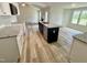 Spacious kitchen features modern appliances, granite countertops, a breakfast bar, and hardwood style flooring at 158 Sourgum Ct, Zebulon, NC 27597