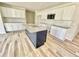 Bright kitchen features white cabinets, granite countertops, tile backsplash, and a large center island at 158 Sourgum Ct, Zebulon, NC 27597