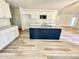 Well-appointed kitchen featuring stainless appliances, granite counters, tile backsplash, and a navy island at 158 Sourgum Ct, Zebulon, NC 27597
