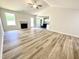 Bright living room with a fireplace, ceiling fan, and durable wood-look flooring at 158 Sourgum Ct, Zebulon, NC 27597