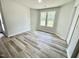 Bright room features hardwood style floors, natural light, and neutral paint, creating a warm and inviting atmosphere at 158 Sourgum Ct, Zebulon, NC 27597