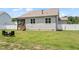 Back exterior of home, featuring a screened-in porch, and backyard seating area with Adirondack chairs at 164 Wilson Farm Ln, Clayton, NC 27527