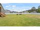 Large green backyard with a white picket fence and backyard seating area with Adirondack chairs at 164 Wilson Farm Ln, Clayton, NC 27527