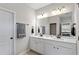 Bright bathroom featuring a double sink vanity, modern fixtures, and a large mirror at 164 Wilson Farm Ln, Clayton, NC 27527