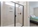 Modern tiled shower with glass door and wall niche; located just off the primary bedroom at 164 Wilson Farm Ln, Clayton, NC 27527