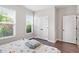 This cozy bedroom features two bright windows, a spacious closet, and luxury vinyl plank flooring at 164 Wilson Farm Ln, Clayton, NC 27527