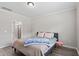 Comfortable bedroom featuring modern gray flooring, a comfortable bed, and an entrance to the bathroom at 164 Wilson Farm Ln, Clayton, NC 27527