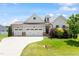 Charming home featuring a three-car garage and beautifully landscaped front yard at 164 Wilson Farm Ln, Clayton, NC 27527