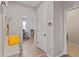 Hallway showcasing a built-in bench with coat hooks and bright yellow pillow, with an office visible at 164 Wilson Farm Ln, Clayton, NC 27527