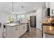 Bright kitchen featuring a large island, stainless steel appliances, and wood floors at 164 Wilson Farm Ln, Clayton, NC 27527