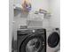 The laundry room includes modern Samsung washer and dryer, with ample shelving above at 164 Wilson Farm Ln, Clayton, NC 27527
